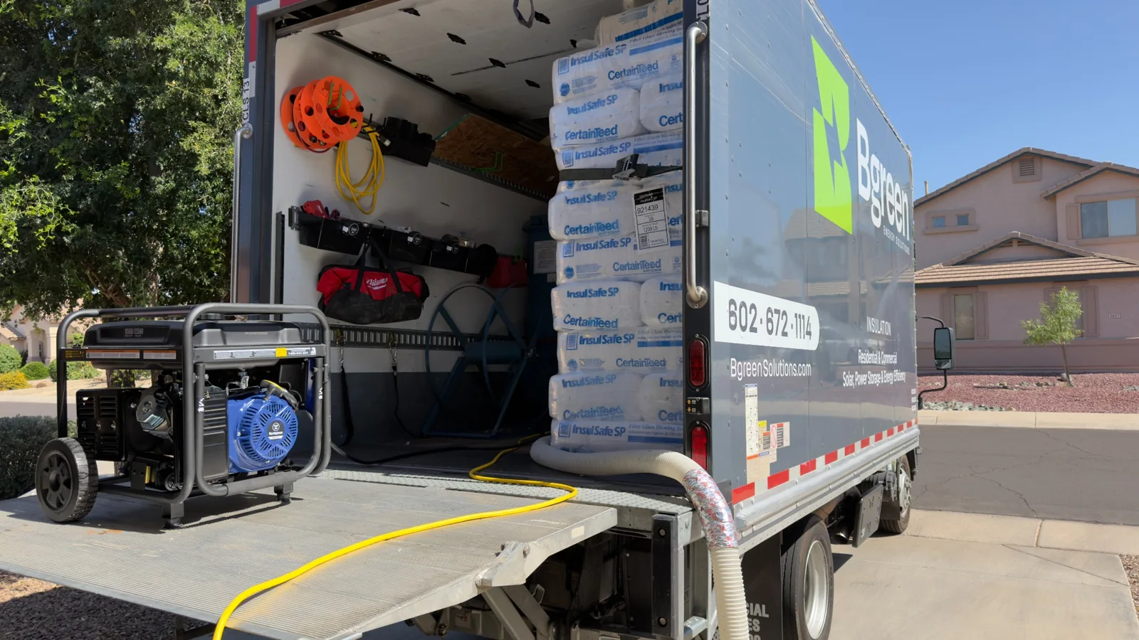 Bgreen truck loaded with insulation blowing equipment and fiberglass bags